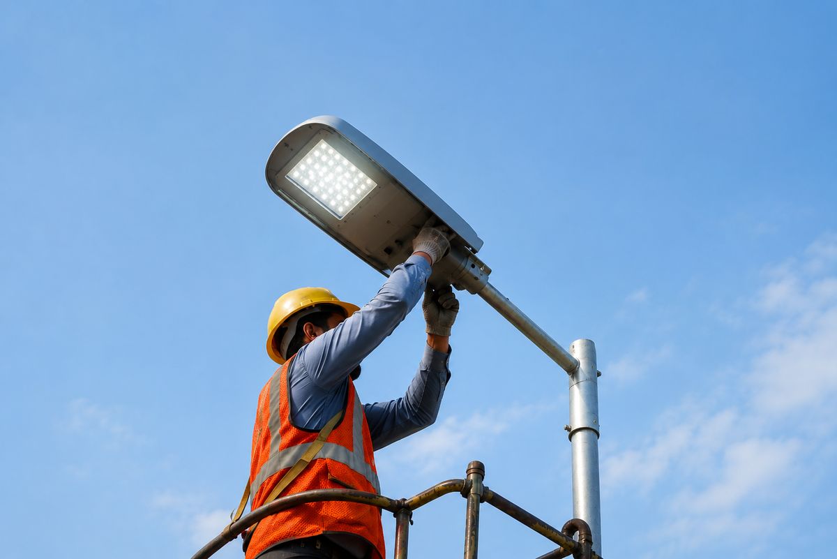 Technician installing an LED street light